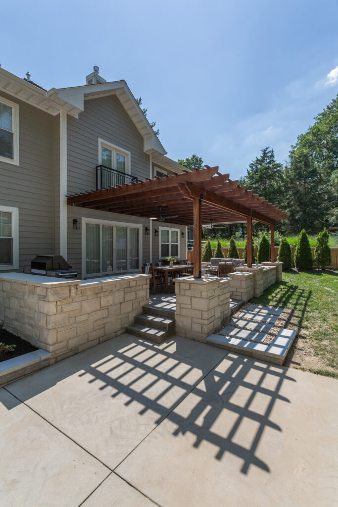 Wide shot - Exterior of home with Pergola and patio built by Rosette Forever Homes