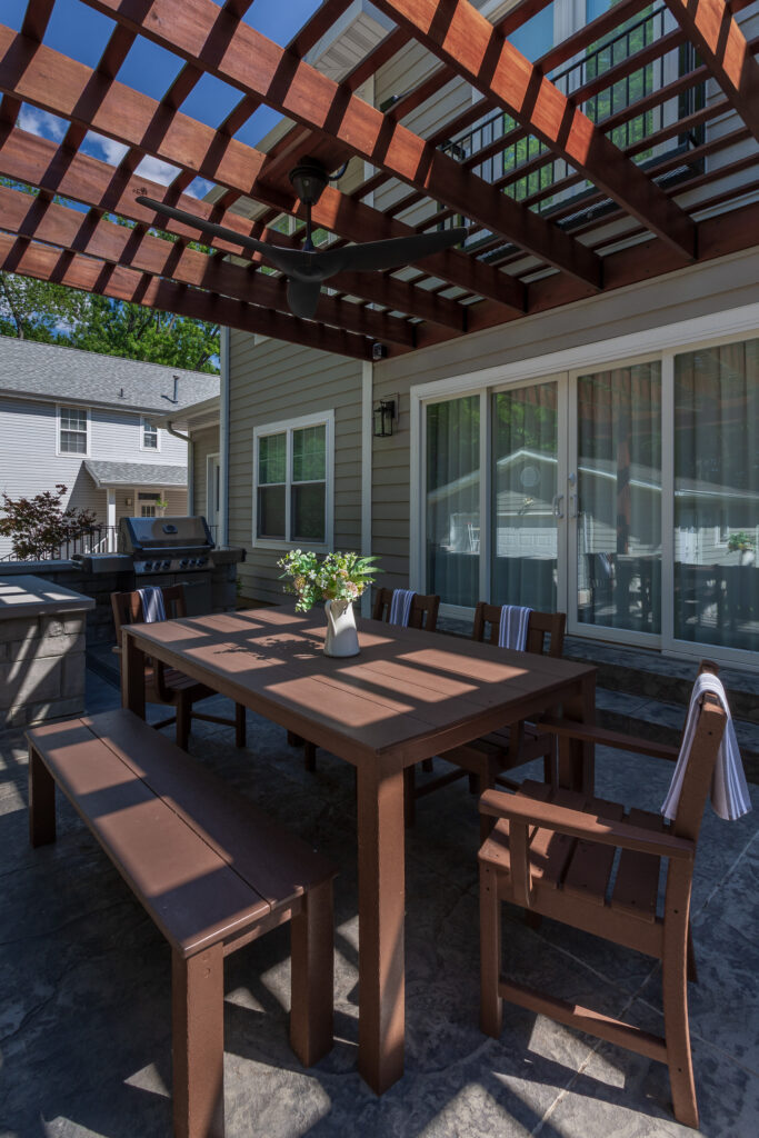 Dining table under the pergola and the grill